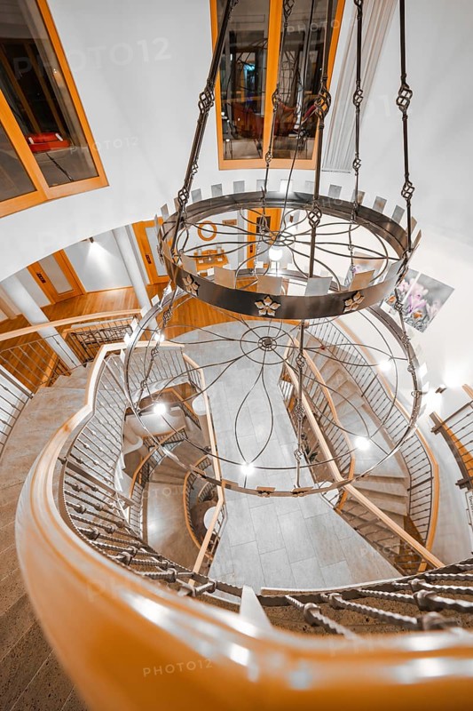 View from above of an elegant staircase with chandelier and wooden banister, Hotel Krone Lamm, Zavelstein, Black Forest, Germany