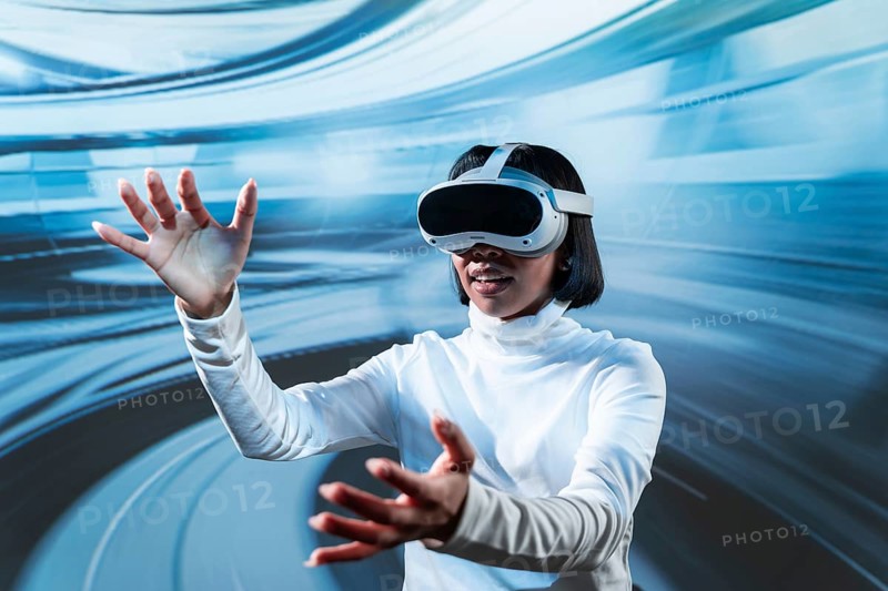 Latin woman immersed in a virtual reality experience, wearing VR glasses and engaging with a dynamic digital environment, symbolizing innovation and modern technology
