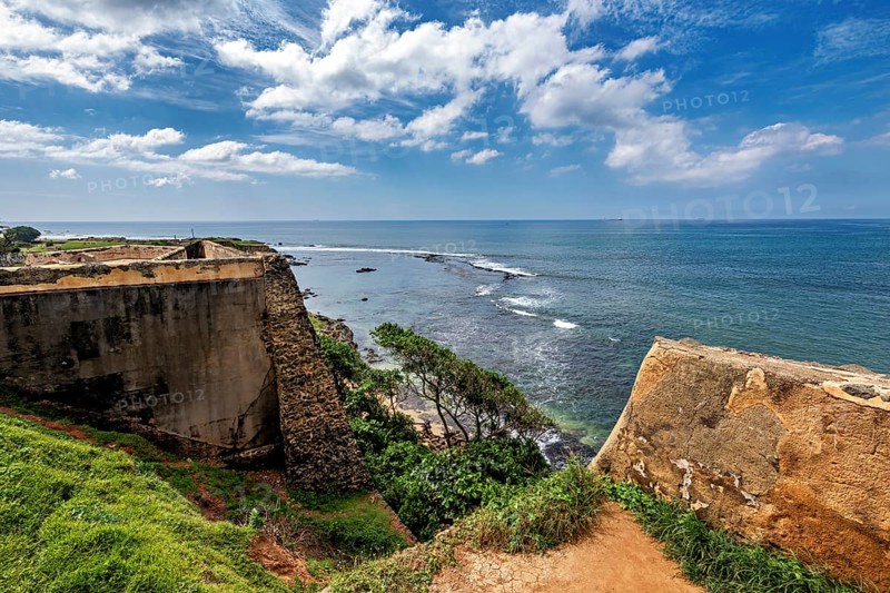 Fortress on a rocky coast with blue sea and cloudy sky, The fortress of Galle in Sri Lanka