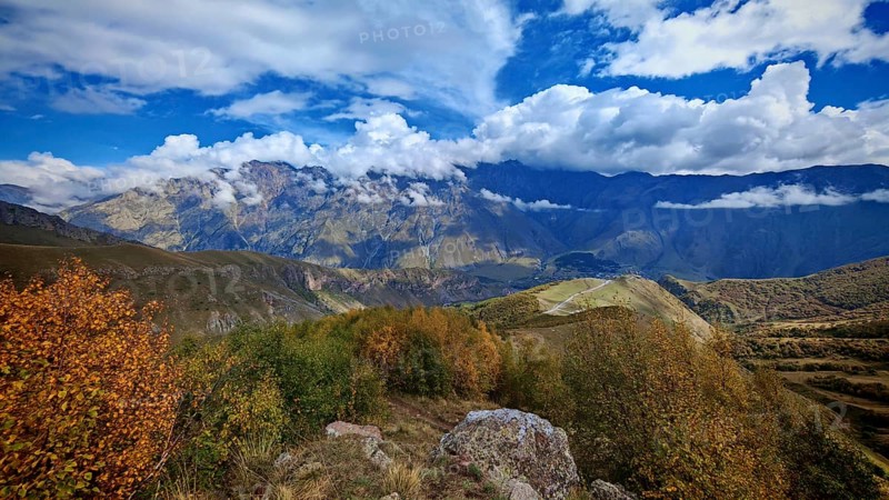 Autumn landscape with colorful foliage against a mountain backdrop, Stepantsminda, Caucasus, Georgia