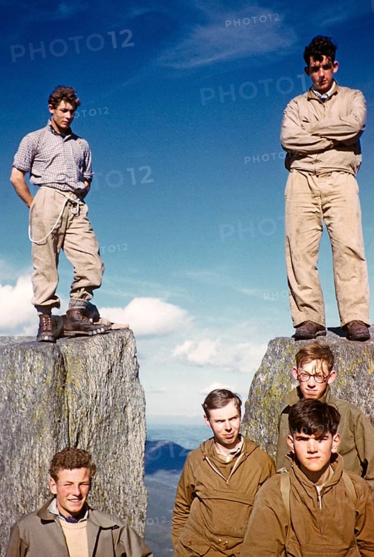 Group of young male climbers standing high on a rock, probably North Wales, United Kingdom, c. 1958