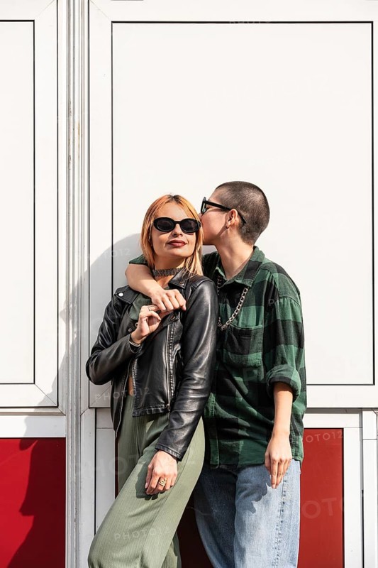 A Colombian lesbian couple embraces outdoors. They exude love, confidence, and identity, celebrating LGBTQIA+ pride, diversity, and equality with their unique style and connection