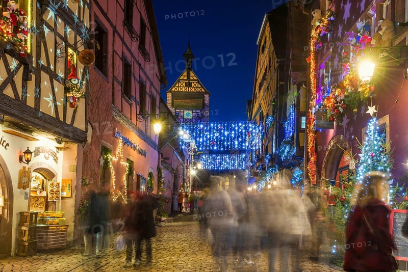 Colour-illuminated and Christmassy decorated half-timbered houses, blue hour, Christmas market, Riquewihr, Grand Est, Haut-Rhin, Alsace, France