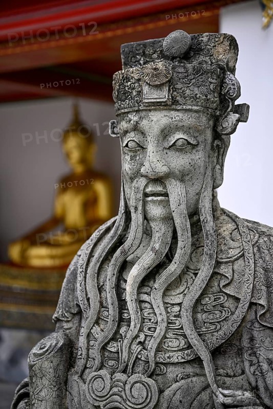 Stone statue of a Chinese warrior, guardian, Wat Pho, Temple of the Reclining Buddha, Bangkok, Thailand