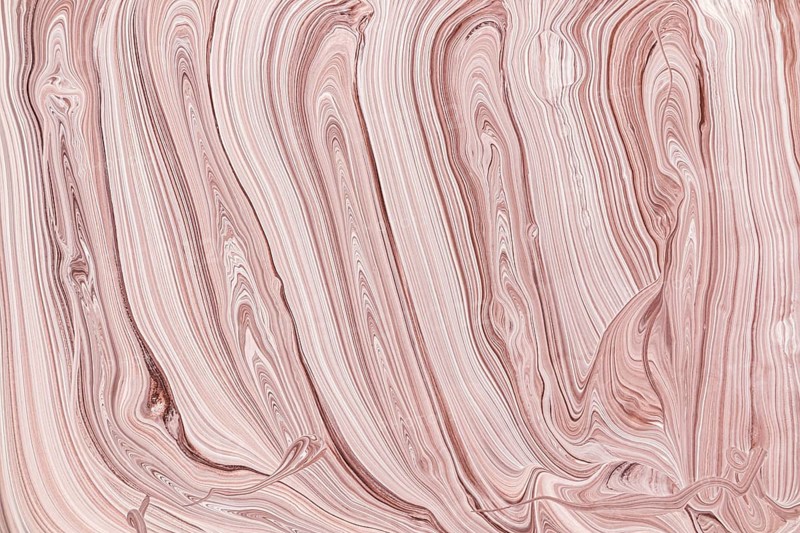 This abstract image features elegant acrylic paint beige and pink swirls. The flowing lines and gentle color blend create a sense of motion and calm, ideal for modern decor or design