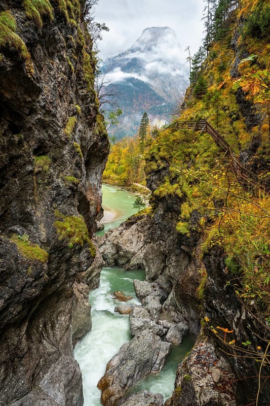 The River Lammer in the Lammerklamm gorge, view from the High Bridge, the footbridge over the river. The path through the gorge on the right. The Tennengebirge mountains in the background. Autumn. Scheffau, Lammertal, Salzburger Land, Upper Austria, Austria