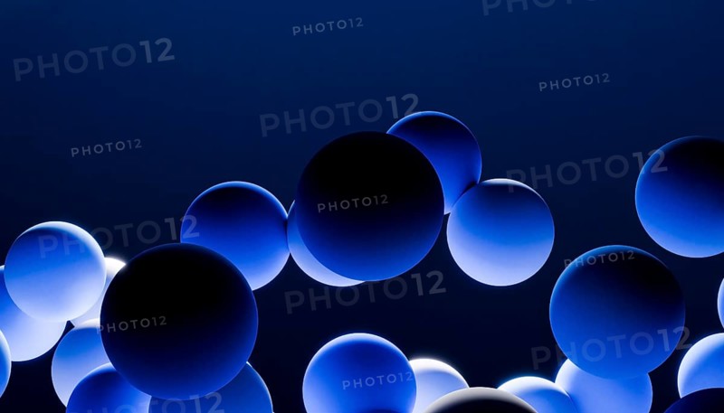 A captivating 3D rendering depicting numerous blue spheres floating harmoniously against a dark background. The spheres display a gradient effect, enhancing their visual appeal