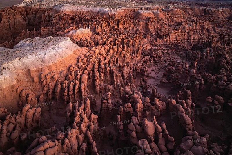 The ethereal view of Goblin Valley State Park in Utah, depicting the layered rock formations and unique hoodoos