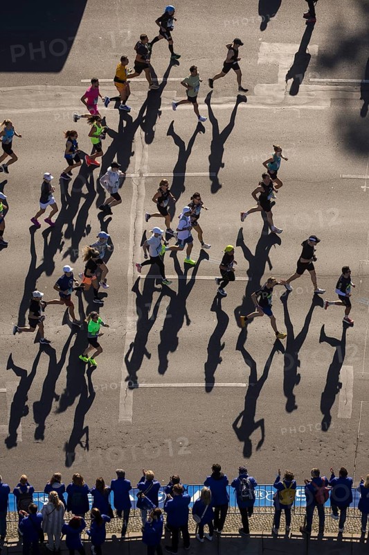 Marathon runners and their shadows at the 50th BMW Berlin Marathon 2024 on 29 September 2024