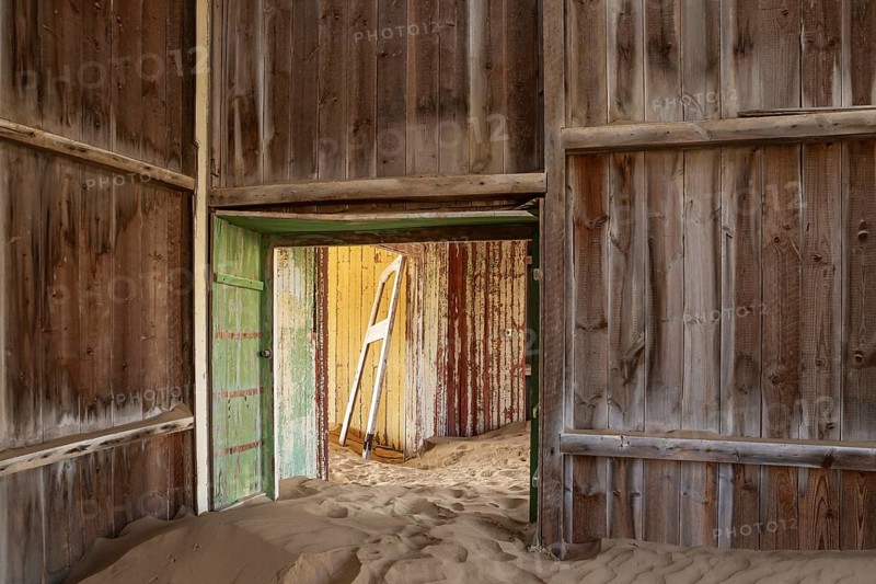 At Kolmanskop, the abandoned ghost town of the diamond days of the early 1900 and of German origin. Inside the restricted Diamond Area east of the coastal town of Lüderitz. Namib Desert, Namibia
