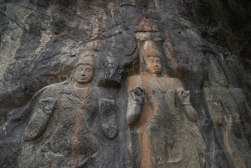 The intricate ancient rock carvings at Buduruwagala highlight Sri Lanka's historical and cultural art, featuring detailed Buddhist figures against a rugged stone backdrop