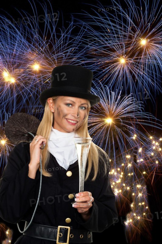 A female chimney sweep in front of New Year's Eve fireworks