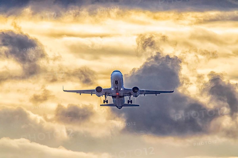 Stuttgart airport with plane taking off. Eurowings Airbus A320 in front of dark clouds, lighting in the evening. Stuttgart, Baden-Württemberg, Germany