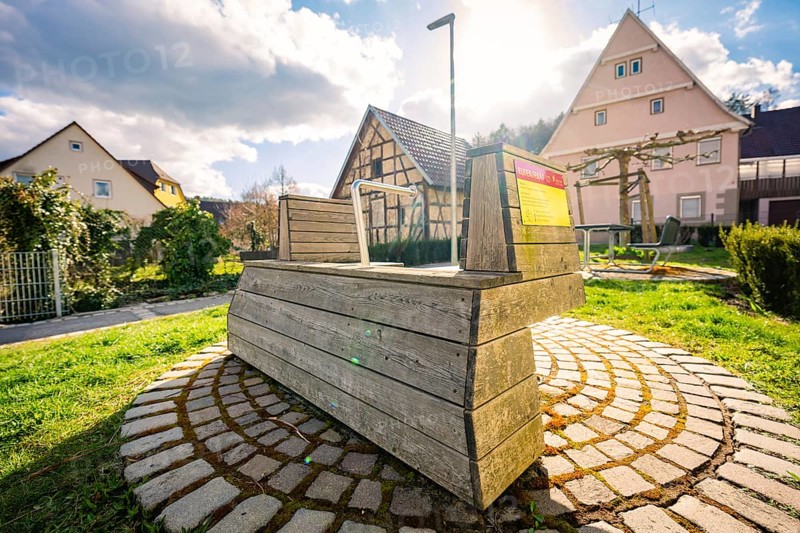 Rowing machine is located in a small village in the sun, surrounded by traditional houses, Deufringen, Aidlingen, Böblingen district, Germany