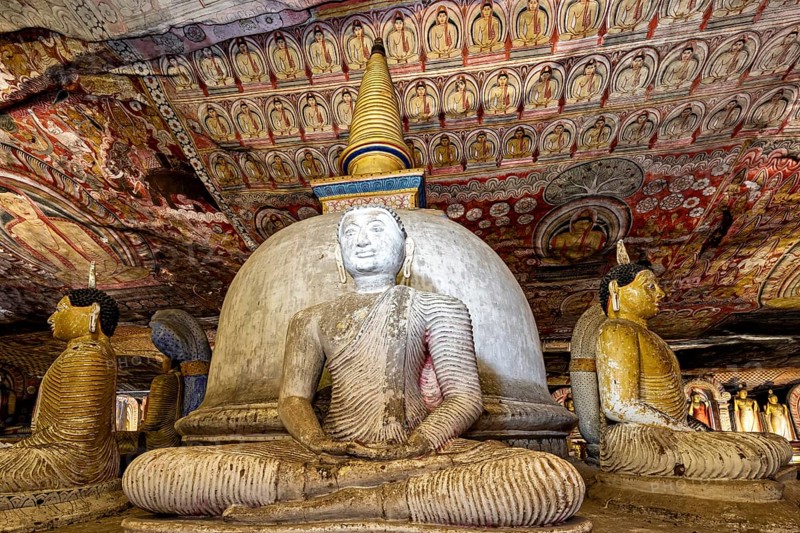 Ancient cave with Buddhist statues and detailed wall paintings, atmosphere of spirituality and history, The cave temple of Dambulla in Sri Lanka