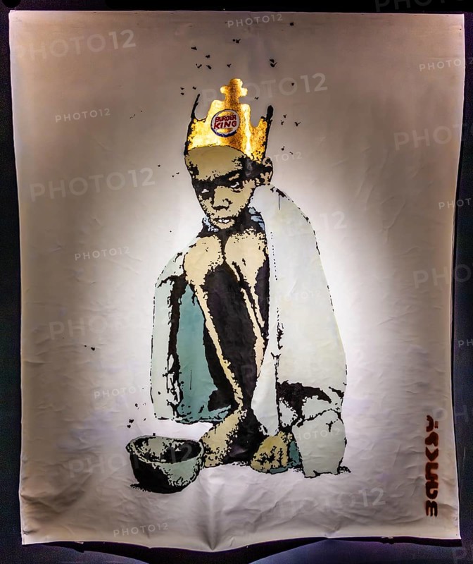 Banksy - Burger King Kid, criticism of fast food and malnourished children, 2006, exhibition The World of Banksy