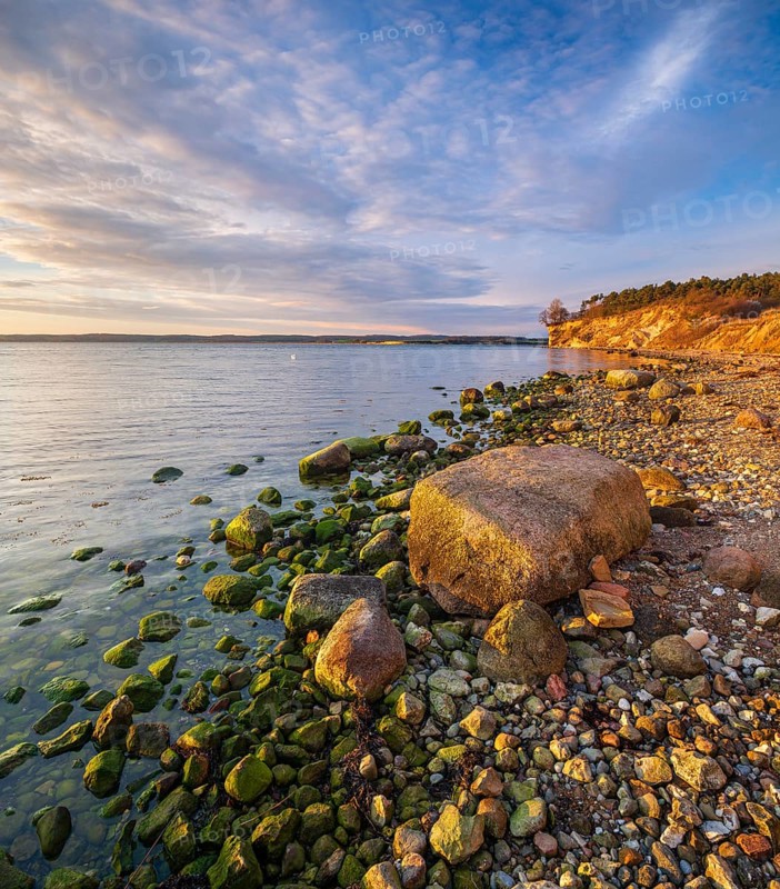 Rocky beach with boulders on the cliffs of the Bay of Greifswald in the evening light, Mönchgut nature reserve, Groß Zicker, Mönchgut peninsula, Rügen island, Mecklenburg-Western Pomerania, Germany