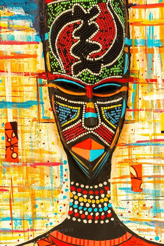 Ghanaian woman as a three-dimensional work of art by a Ghanaian artist, a colourful work of art on canvas, upper part with abstract painting, face mask with artificial pearls, dress made of individual textiles, Ghana