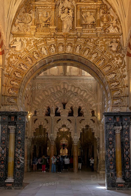 A magnificent interior of the cathedral mosque of Cordoba (Mezquita-Catedral), with richly decorated arches and ornate stonework, Cordoba, Andalusia, Spain