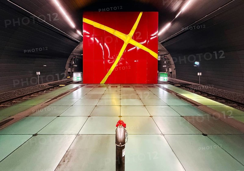 Lohring subway station with red enamelled wall with a painted light cross by Eva-Maria Jöressen, Bochum, North Rhine-Westphalia, Germany