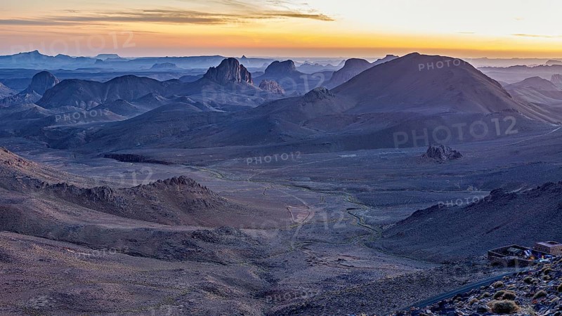 Morning mist over a vast desert landscape at sunset, The landscape of the Ahaggar Mountains in the Sahara in Algeria