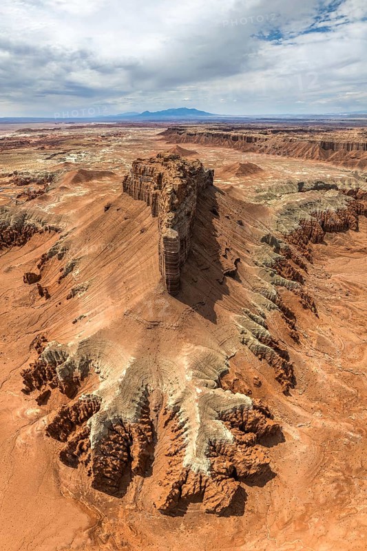 Captivating aerial shot showcasing the unique geological formations and vivid colors of Goblin Valley State Park, set against a dynamic sky in Utah, USA