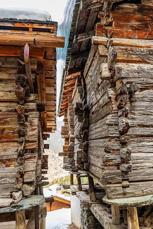 Old, weathered barn on stone slabs, historic town center, Grimentz, Val d'Anniviers, Valais Alps, Canton of Valais, Switzerland