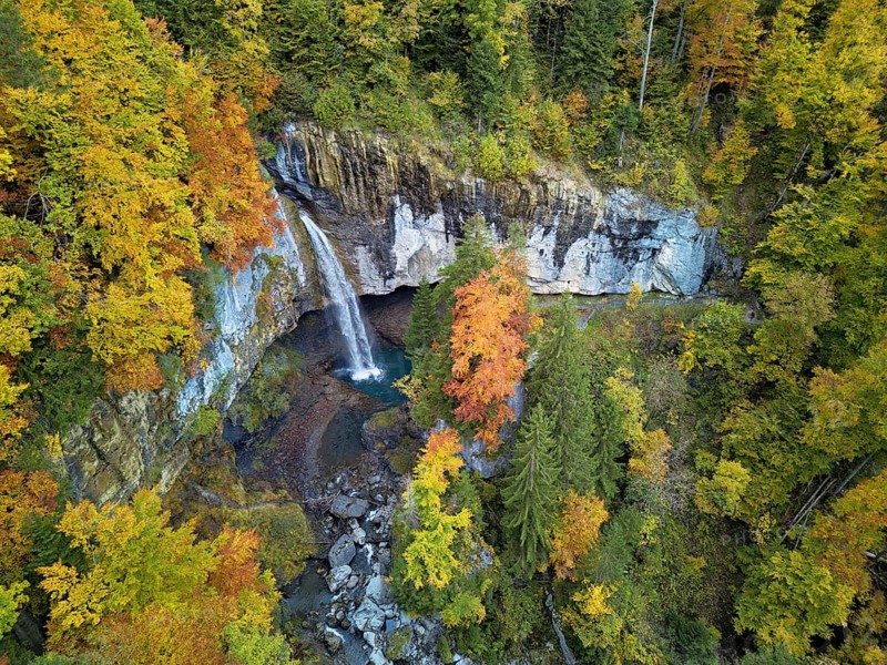 Aerial view of Berglistüber waterfall in autumn-colored surroundings, Linthal, Klausenpass, Canton of Glarus, Switzerland