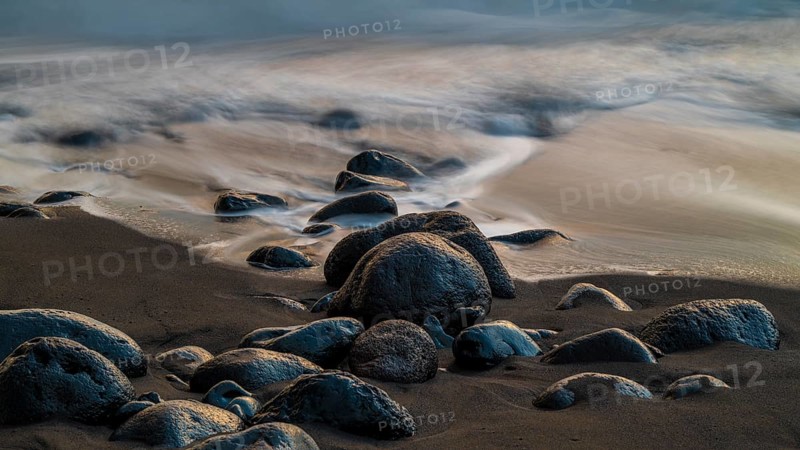 Sunset, waves and rocks in the sea, Praia Formosa, Madeira, Portugal