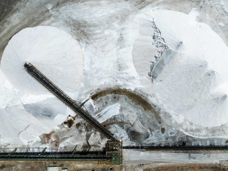 Conveyor belt and salt heaps at the Walvis Bay Salt works. Aerial view. Drone shot. Walvis Bay, Namibia