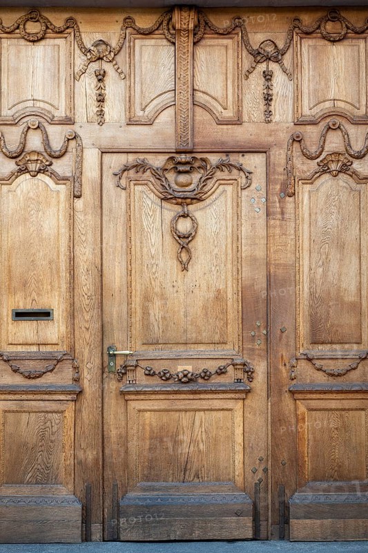 Beautifully decorated, historic wooden door at Falkensteiner Hof in the old town of Basel, Canton of Basel-City, Switzerland