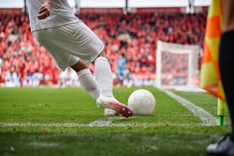 Footballer takes the corner. Detail of player's legs and the ball during soccer match in Lodz, Poland