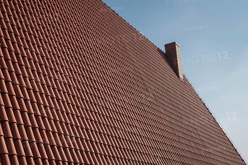 Roof with traditional polish tile and chimney in Poland