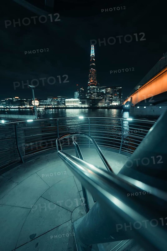 Nocturnal river landscape with illuminated building and bridge view, New Year's Eve London, Great Britain