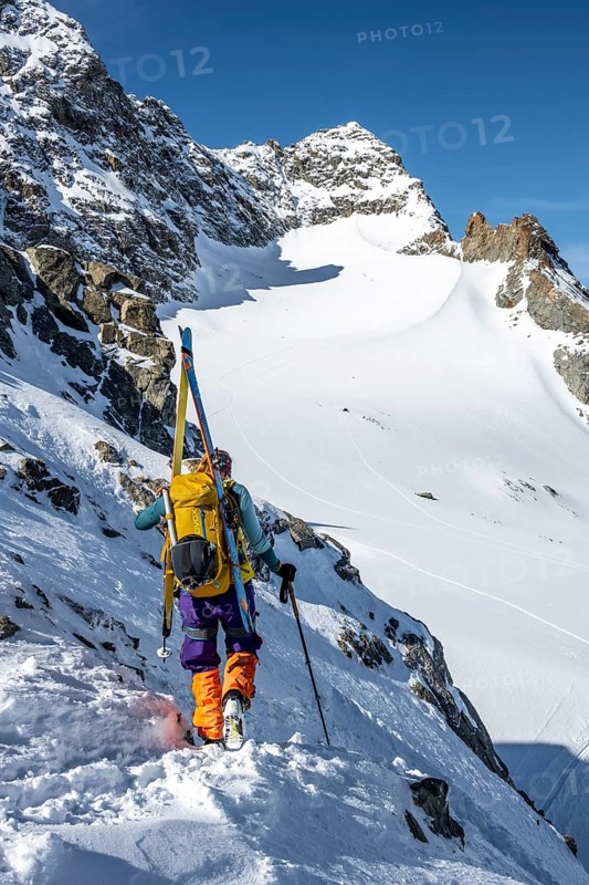 Mountaineer with skis at the fork Porta d'Es-cha, view of mountain peak Piz Kesch and glacier Vadret da Porchabella, ski tour Bündner Haute Route, Albula Alps, Rhaetian Alps, Grisons, Eastern Switzerland, Switzerland