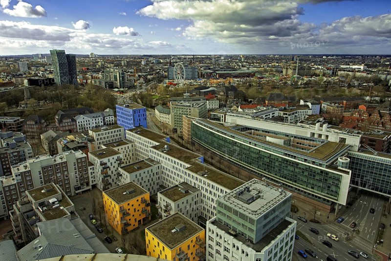 View of a modern urban district from the observation deck of Hamburger Michels, distinctive architecture under a blue sky, Hamburg, Germany