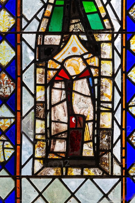 Stained glass of east window medieval fragments, Church of Saint Nicholas, Rushbrooke, Suffolk, England, UK, depiction of a saint