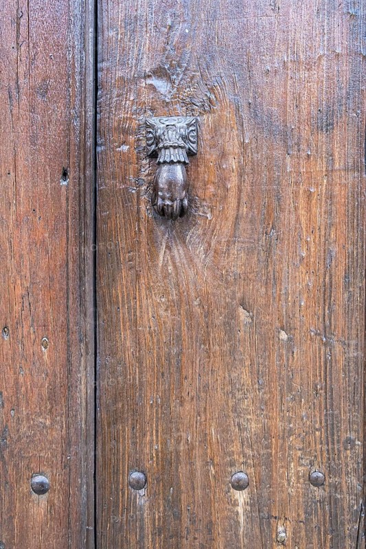 Hand as a door knocker on an old front door, Prizren, Kosovo, Balkans