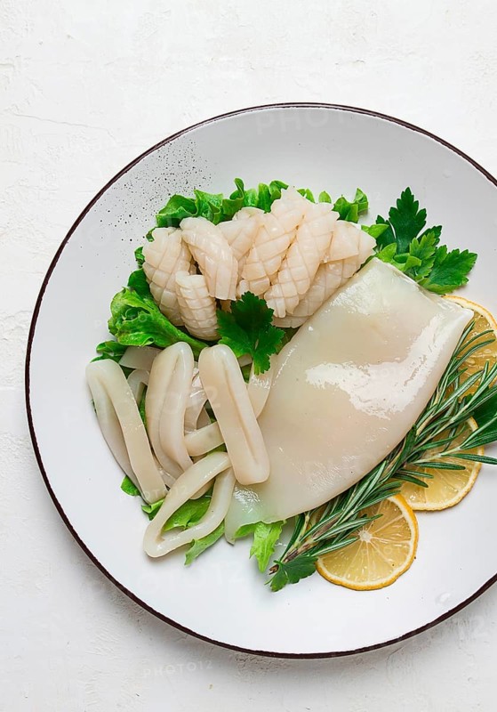 Fresh squid, raw, carcass, cut into rings, top view, no people