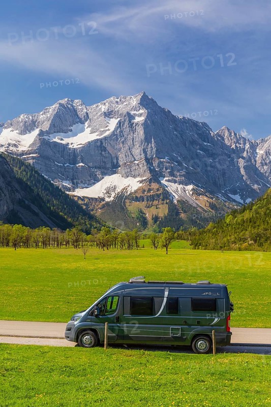Camper van, Nature conservancy area Grosser Ahornboden. Sycamore maple trees, Acer pseudoplatanus, in springtime. Karwendel Mountains, Austria