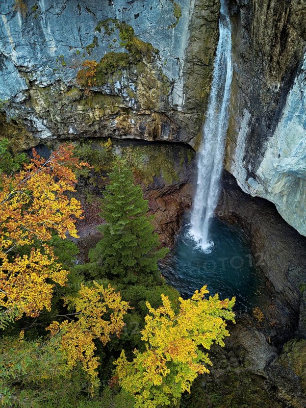 Aerial view of Berglistüber waterfall in autumn-colored surroundings, Linthal, Klausenpass, Canton of Glarus, Switzerland