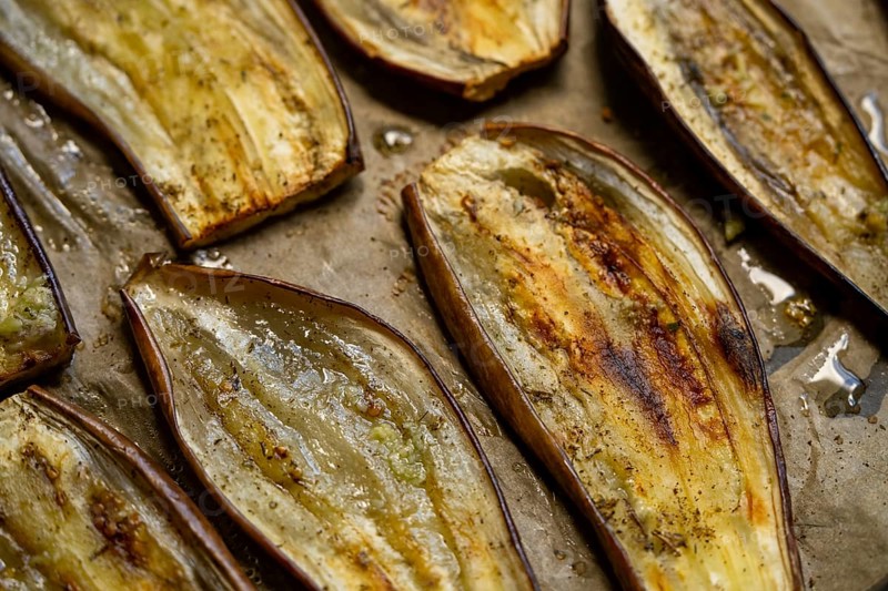 Close-up of oven roasted eggplant slices showcasing a rustic, healthy dish perfect for vegetarian and vegan meals. Ideal for Mediterranean cuisine lovers and plant-based diets
