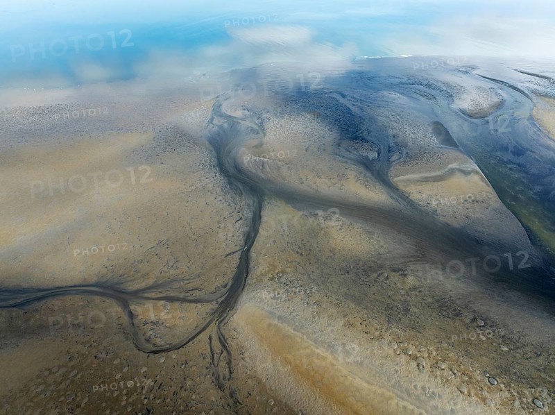 Streams and marshes at low tide in the coastal wetlands of the Walvis Bay lagoon. Aerial view. Drone shot. Walvis Bay, Namibia