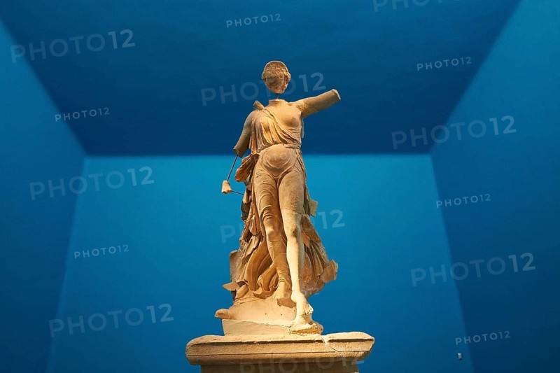 The Nike of Paionios, statue of the goddess of victory Nike from Parisian marble, marble sculpture of a woman, frontal in a room with blue walls, Olympia Archaeological Museum, Ancient Olympia, Olympia, Peloponnese, Greece