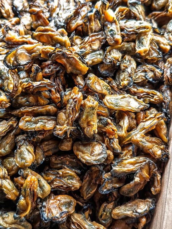 High-detail photo of sun-dried mussels, commonly sold in local markets in Singapore, showcasing their unique texture and natural color variation