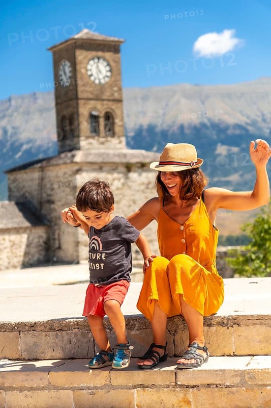 Mother and son having fun at the Clock Tower in the Ottoman Castle Fortress of Gjirokaster or Gjirokastra. Albanian