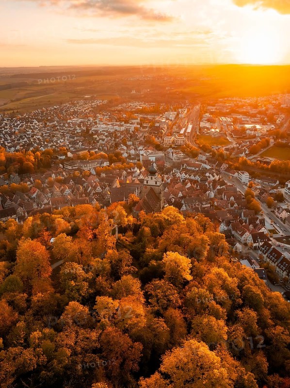 Autumn-coloured cityscape at sunset, surrounded by forests, Herrenberg, Germany