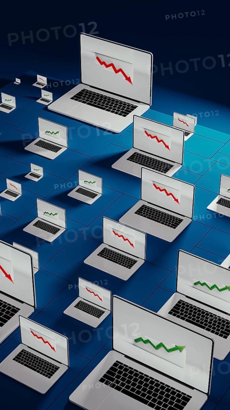 Laptops in a modern office show fluctuating stock trends, reflecting the dynamic nature of financial activities