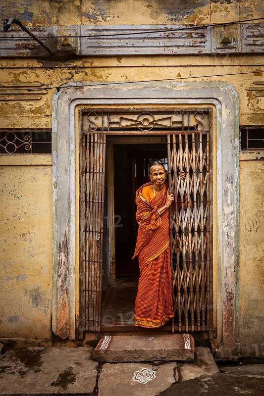 TIRUCHIRAPPALLI, INDIA, FEBRUARY 15, 2013: Unidentified India woman standing in the doorway of her house