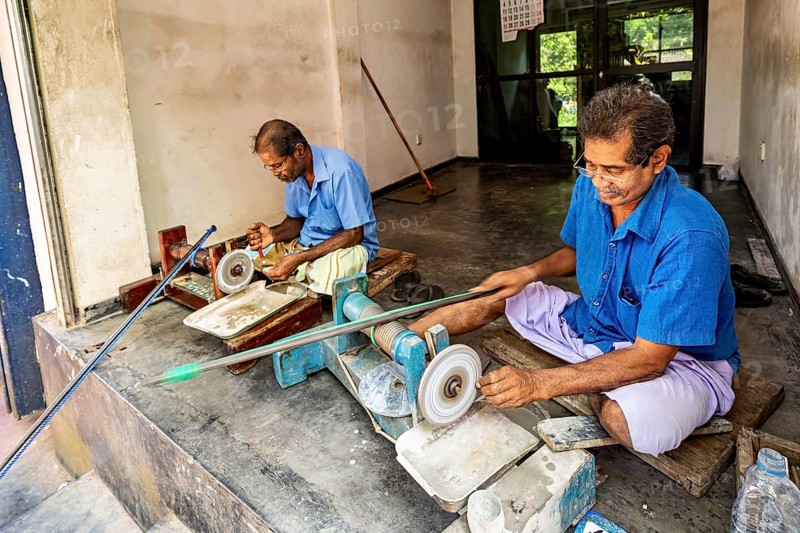 In the workshop two men work on machines with care and precision, the gemstone cutters in the city of Ratnapura in Sri Lanka